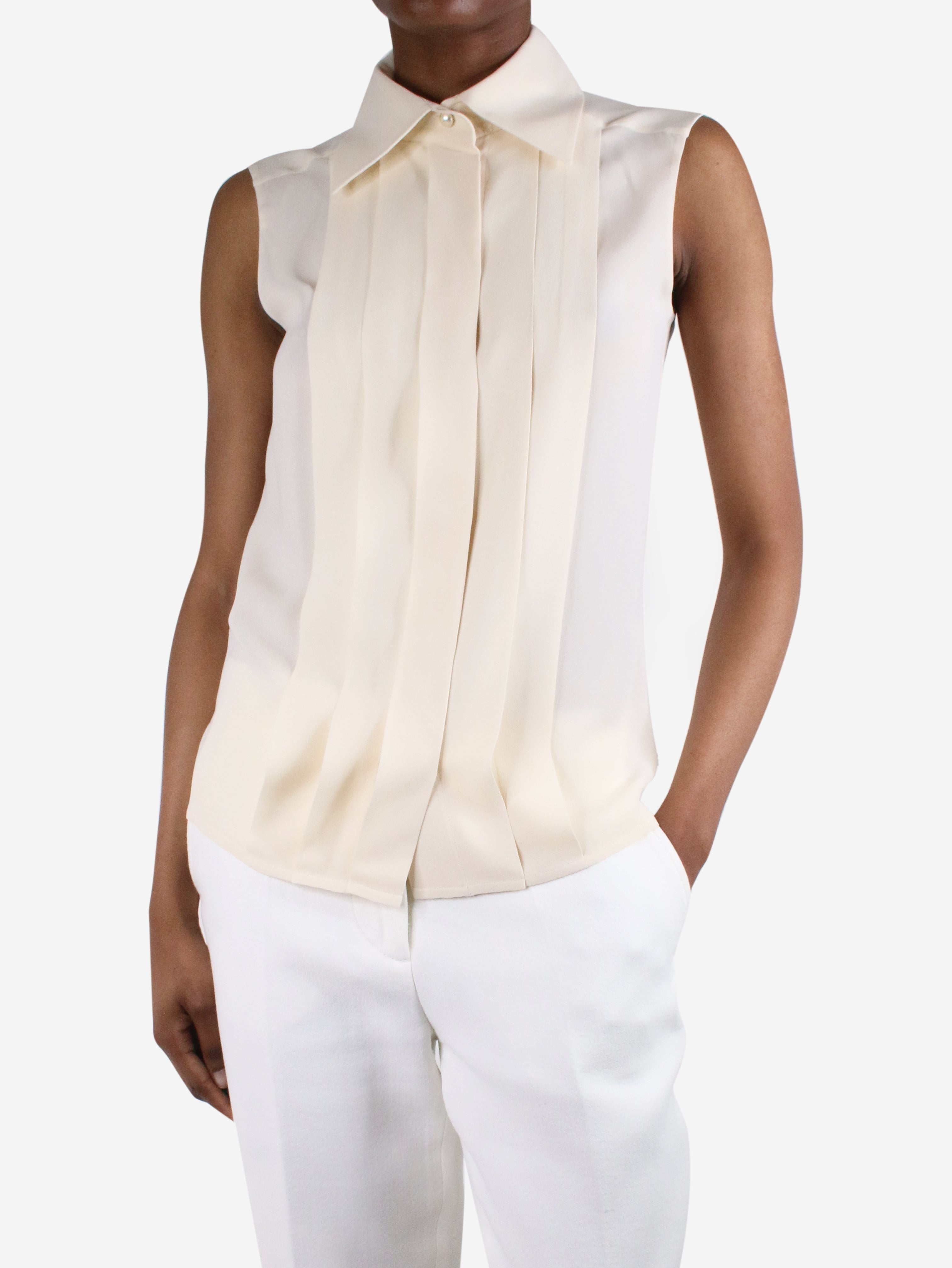 Chanel pre-owned cream sleeveless silk blouse.